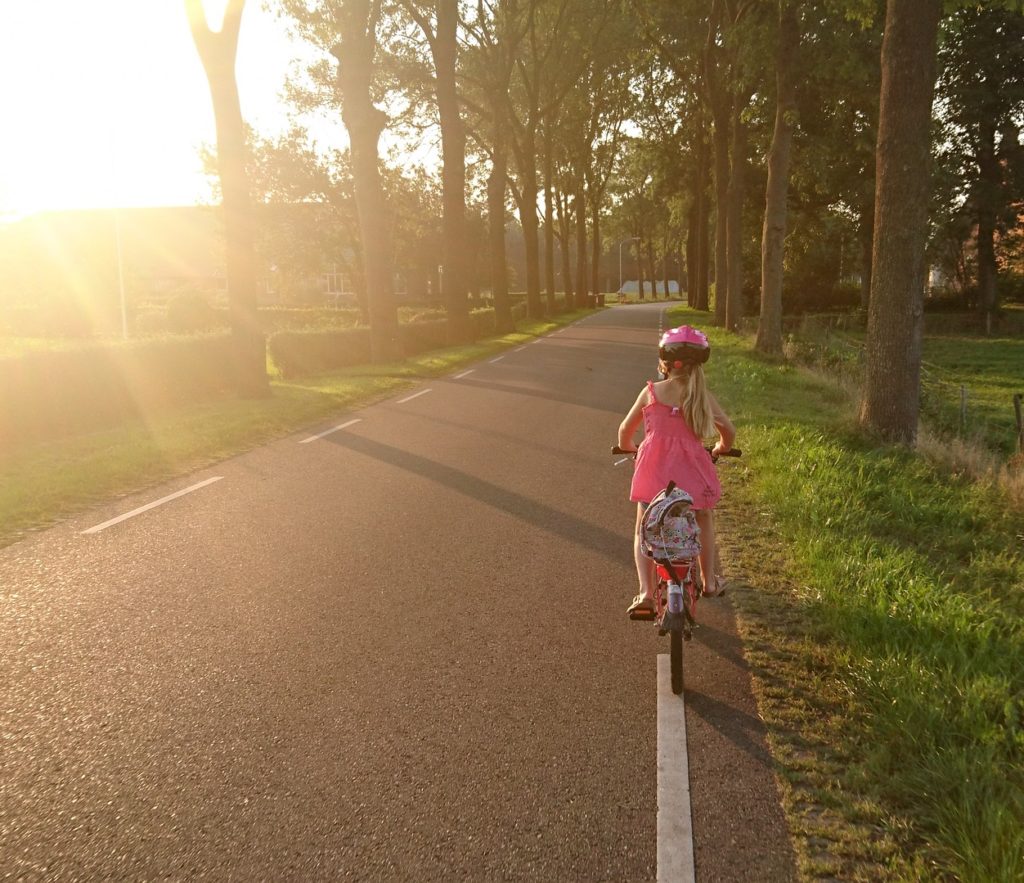 A girl riding a bike on a road in Northern Virginia